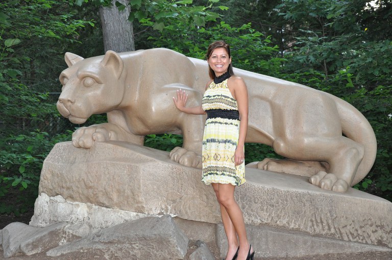 While attending the Summer Institute, a CEDEV student gets a photo opportunity with the lion shrine at University Park.
