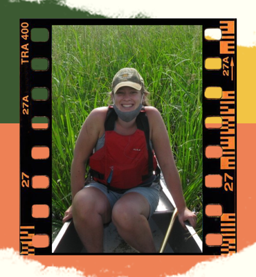 Photo of Maddy Nyblade sitting in a canoe amongst wild rice