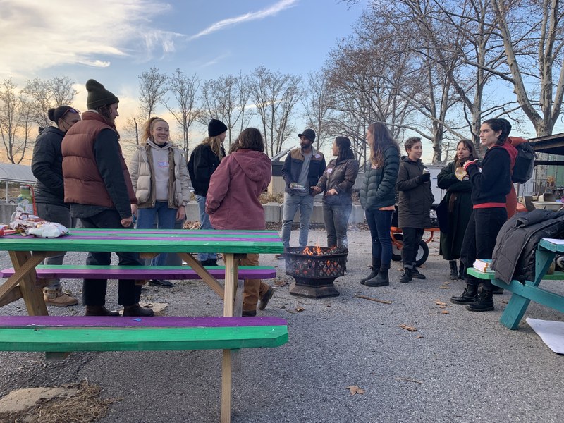 Group of people standing near a fire pit